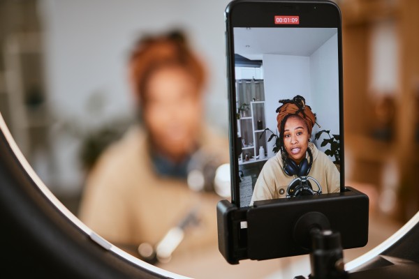 student filming herself in front of camera phone